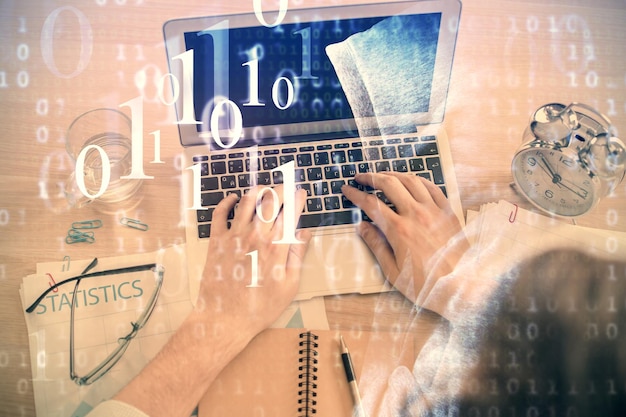 double exposure of mans hands typing over computer keyboard and data theme hologram drawing top view technology concept