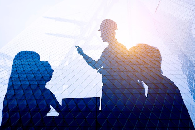 Double exposure of people having business meeting with highrise building glass