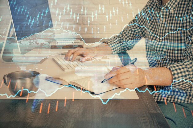 Double exposure of stock market chart with man working on computer on background Concept of financial analysis