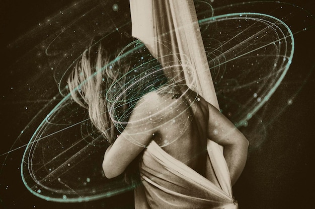 Double exposure of woman covering with fabric and light trails against black background