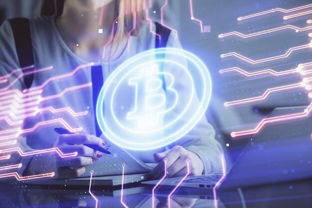 Double exposure of woman hands typing on computer and crypto market theme hologram drawing Blockchain concept