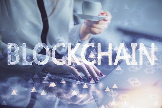 Double exposure of woman hands typing on computer and crypto market theme hologram drawing Blockchain concept