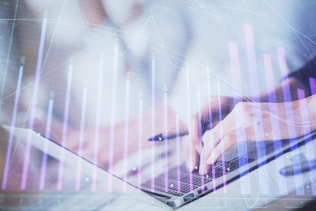 Double exposure of woman hands typing on computer and forex chart hologram drawing Stock market invest concept