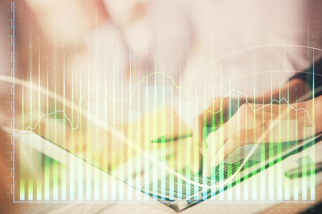 Double exposure of woman hands typing on computer and forex chart hologram drawing Stock market invest concept