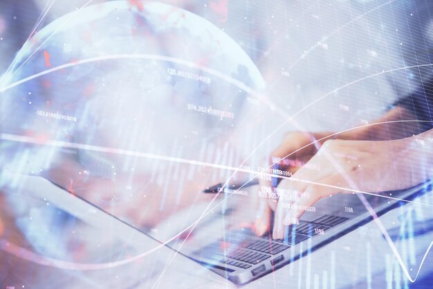 Double exposure of woman hands typing on computer and forex chart hologram drawing Stock market invest concept