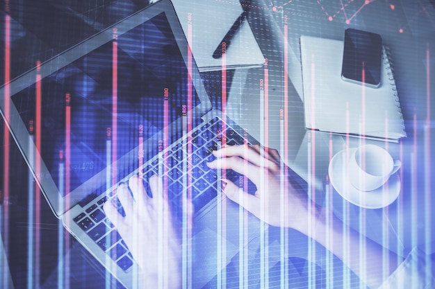 Double exposure of woman hands typing on computer and forex chart hologram drawing Stock market invest concept