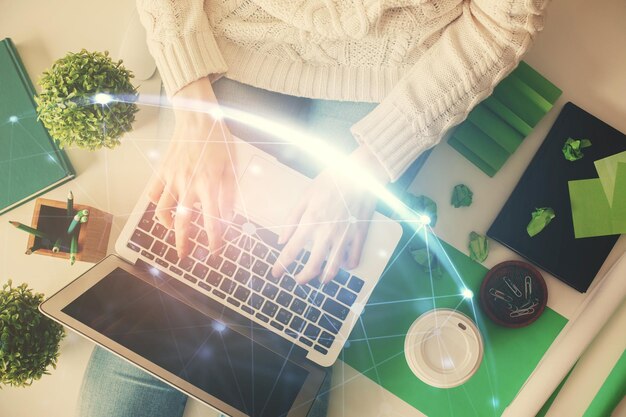 double exposure of woman hands working on computer and social network theme hologram drawing top view people connection concept