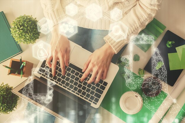 double exposure of woman hands working on computer and tech theme hologram drawing top view technology concept