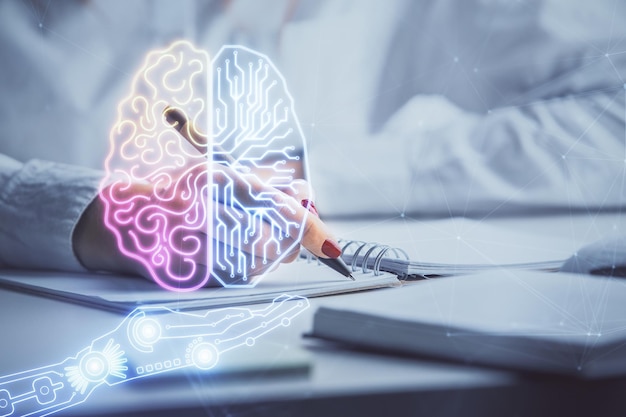 Double exposure of woman's writing hand on background with brain hologram Concept of brainstorming