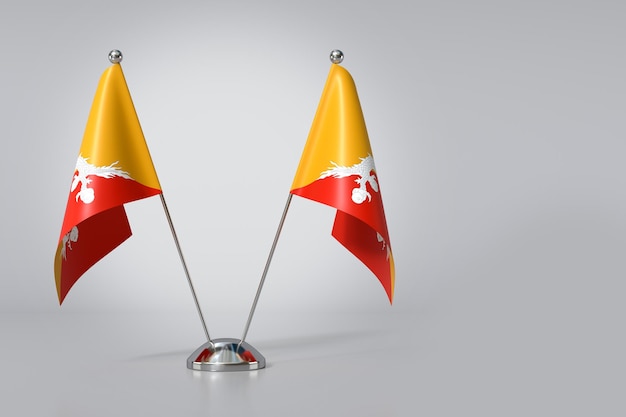 Photo double kingdom of bhutan table flag on gray background 3d rendering