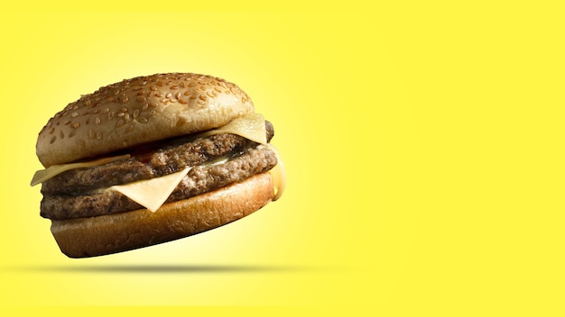 double meat cheeseburger on yellow background