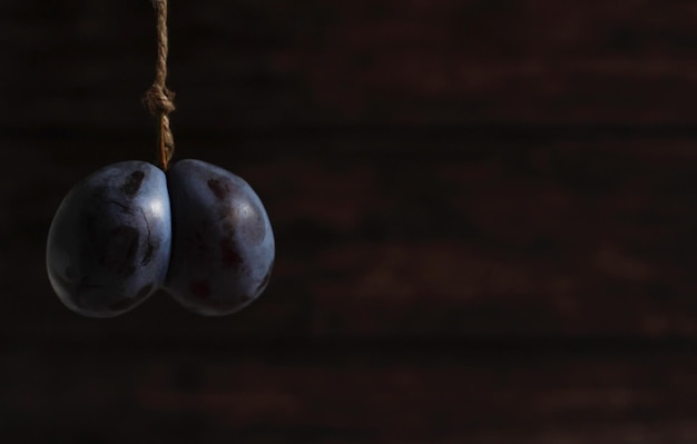 Double original large plum on a wooden background