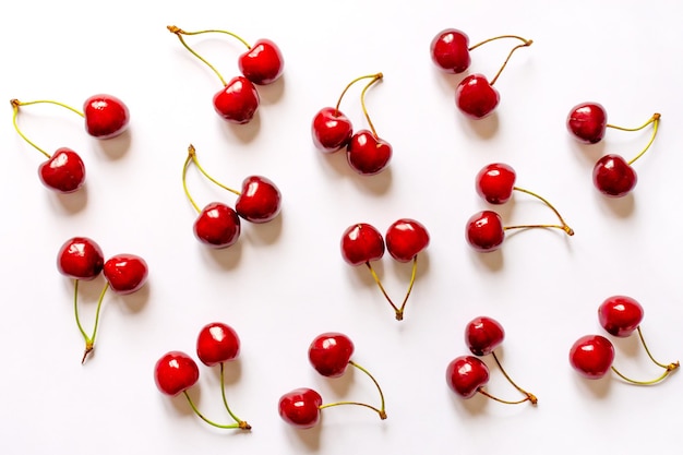 Double red cherries on white background summer