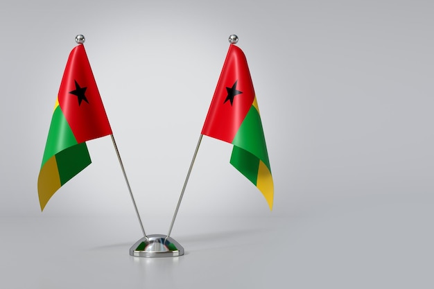 Photo double republic of guineabissau table flag on gray background 3d rendering