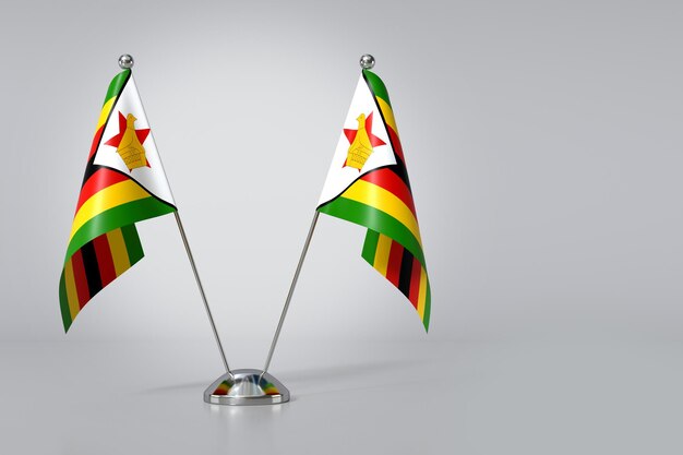 Photo double republic of zimbabwe table flag on gray background 3d rendering