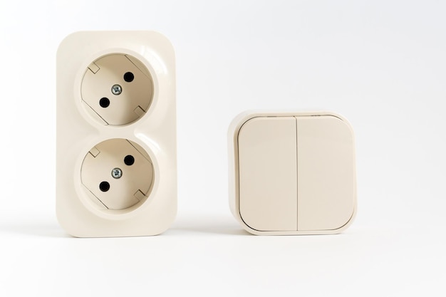 Double socket and twokey light switch on white background