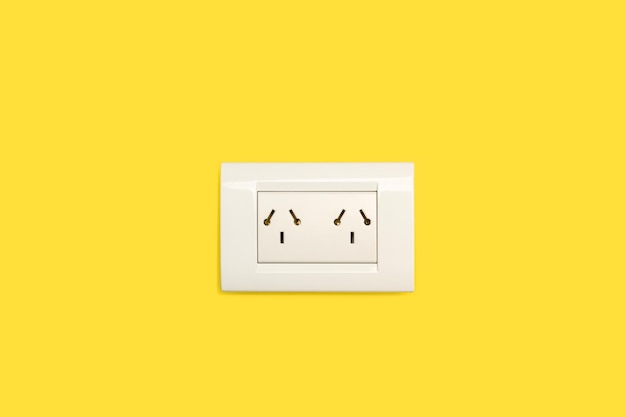 Double wall socket on a yellow background with copy space