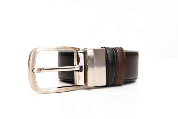 Doublesided black and brown leather belt with an unbuttoned buckle on a white background