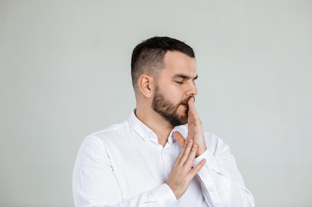 Doubtful bearded man on gray background