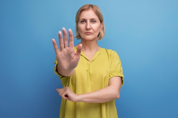 Doubtful blond middle aged woman showing disagreement gesture