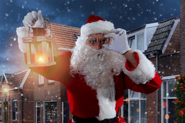 Doubtful santa claus with a vintage lantern