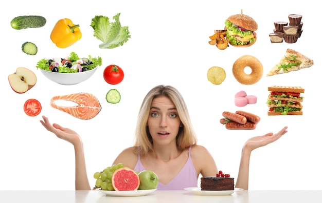 doubtful woman choosing between between healthy and unhealthy food on white background