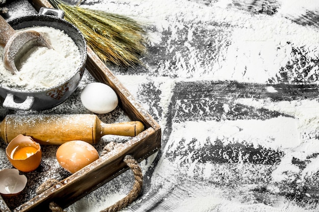 Dough backround. Flour with eggs and rolling pin.