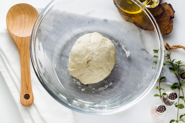 Dough in a glass bowl on the table