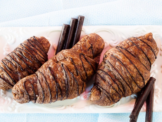 The dough is layered with butter, rolled and folded several times in succession, then rolled into a sheet, in a technique called laminating.