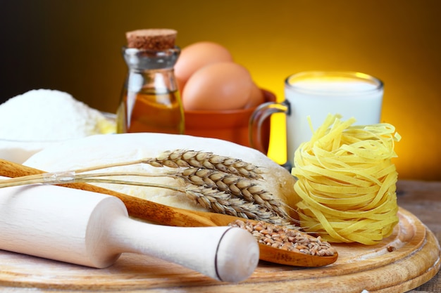 Dough and pasta on a wooden board