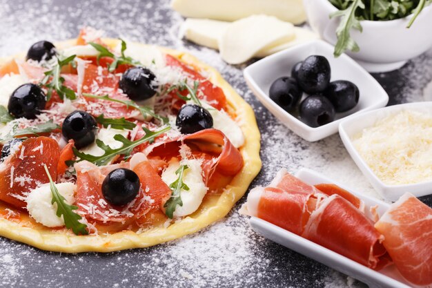 Dough pizza with ingredient.