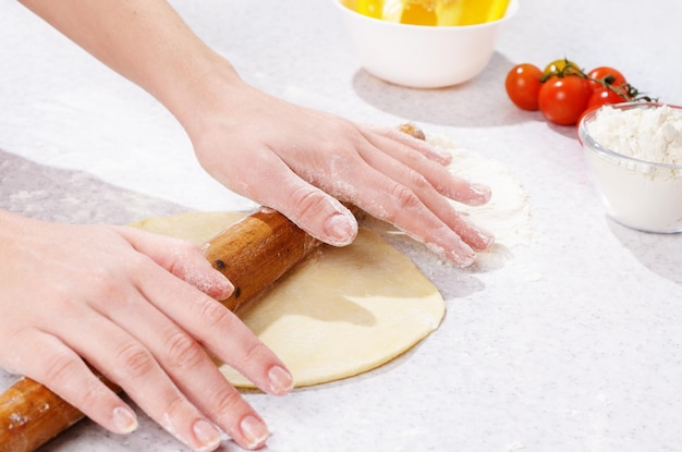 Dough preparing with wooden roller