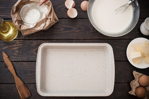 Dough  and products for its preparation on  dark wooden table