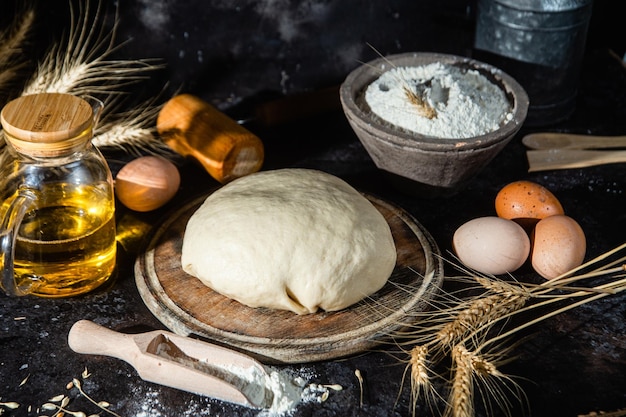 Dough on the table on a dark background.Flour,butter,eggs

