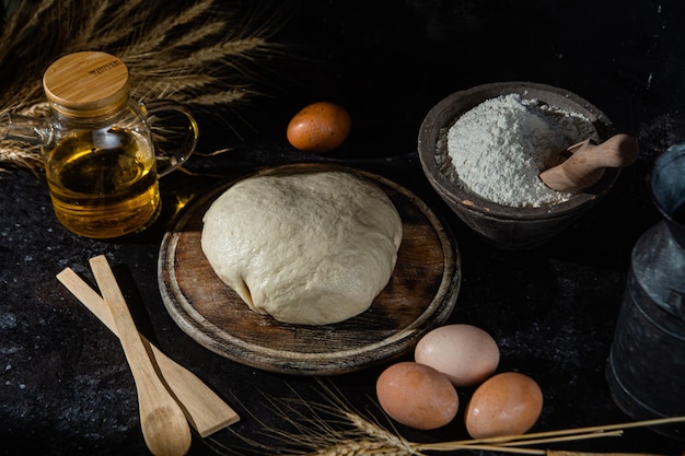 Dough on the table on a dark background.Flour,butter,eggs

