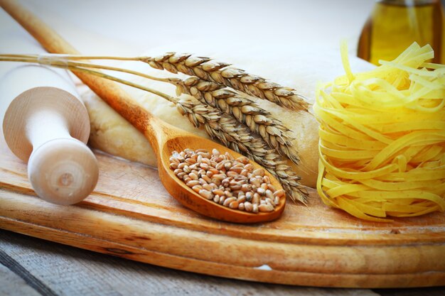 Dough and wheat on a wooden board