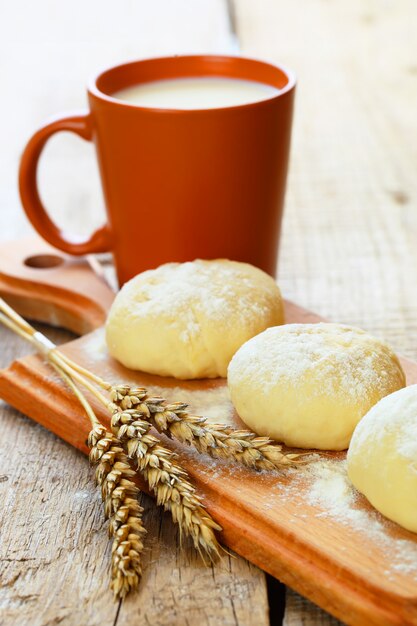 Dough and wheat on a wooden board