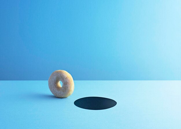 Doughnut and hole on light blue ground