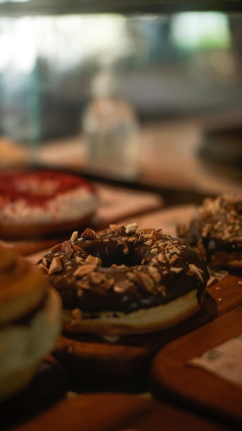 A doughnut with chocolate frosting and nuts on it