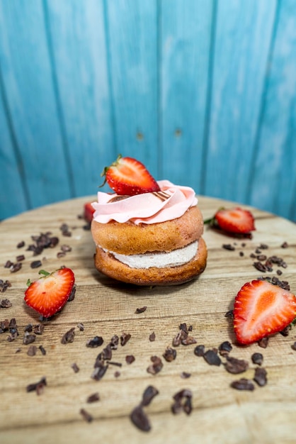 doughnut with strawberry filling, on a wooden plate