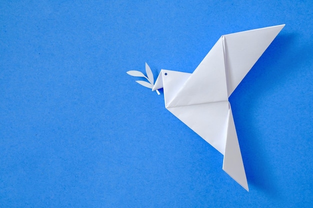 Dove of peace on blue sky background concept from origami