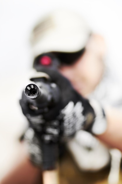 Photo down a barrel. closeup selective focus on the barrel of a gun held by a soldier.