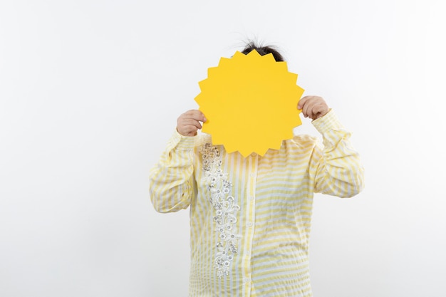 Down syndrome girl in eyeglasses standing with blank speech bubble.