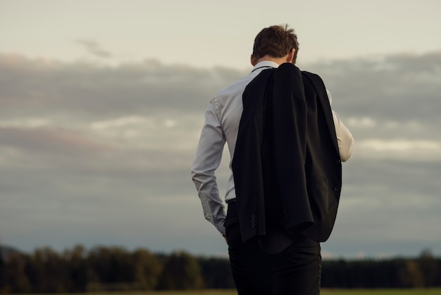 Downhearted businessman standing outdoors