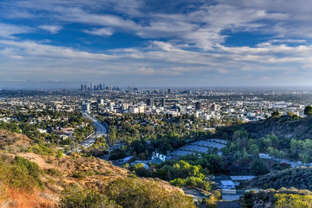 Downtown Los Angeles skyline over blue cloudy sky in California from Hollywood Hills