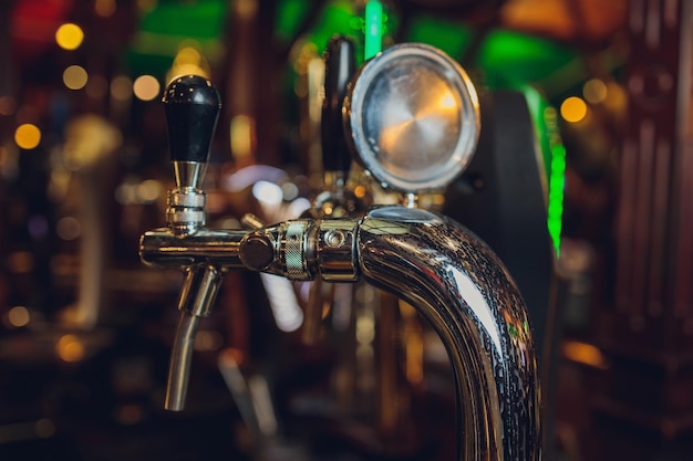 Draft beer tap covered in condensation water droplets