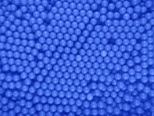 Dragee balls background dark blue