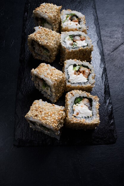 Dragon eel sushi rolls in sesame seeds