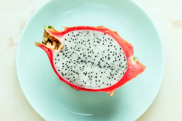 Dragon fruit on a blue plate top view