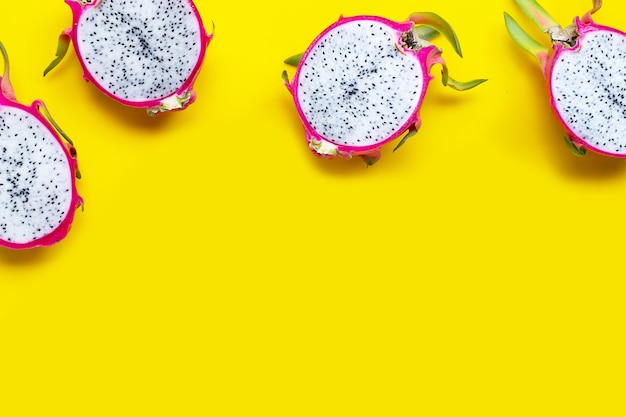 Dragon fruit or pitaya on yellow. Top view